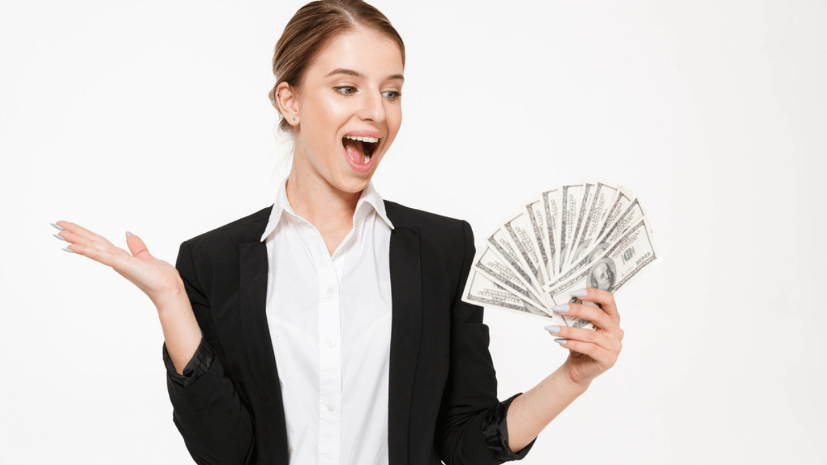 Happy business woman holding money