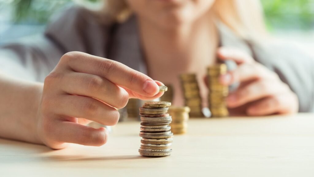 Woman Stacking Coins Stock