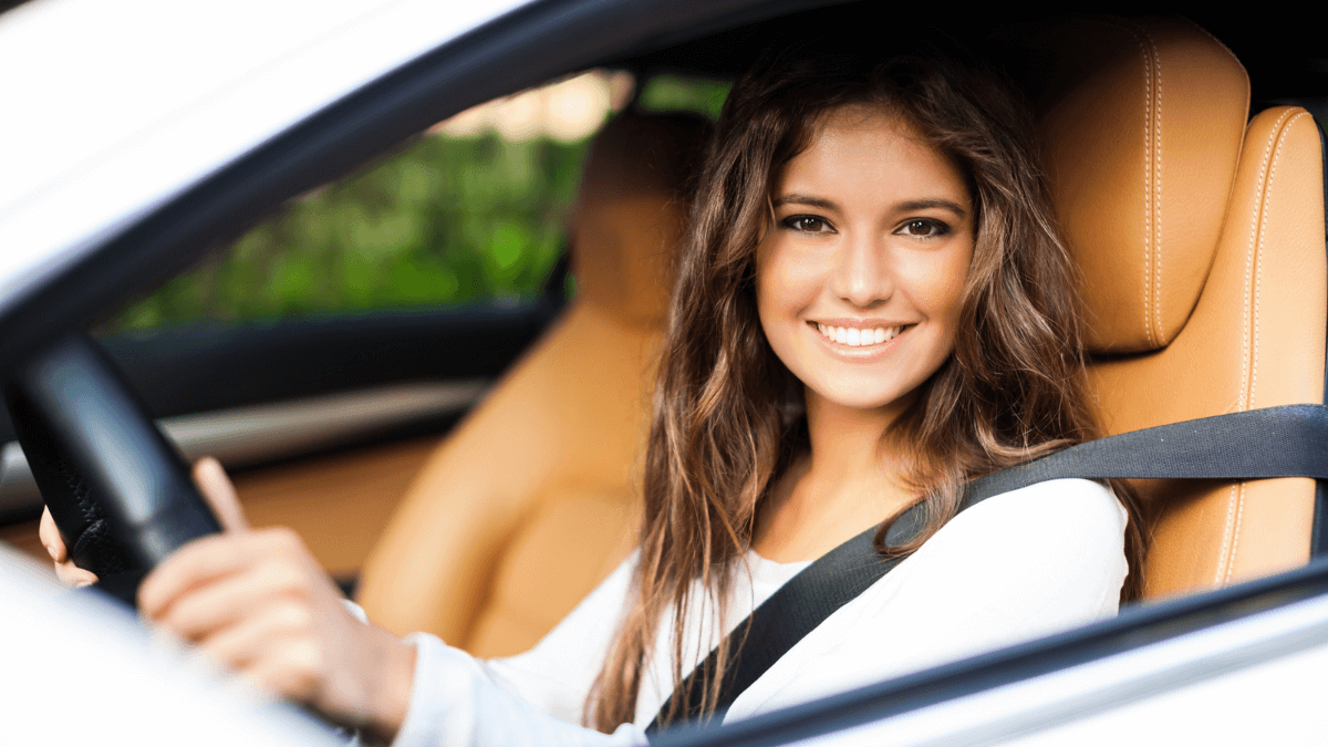 Woman Smiling and Driving in Car Behind the Wheel MSN