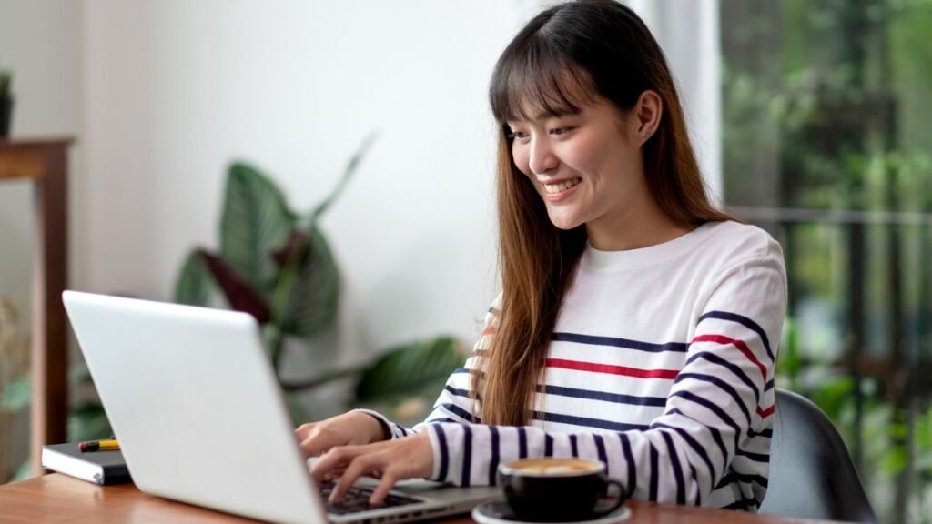 Woman working on a laptop in a café