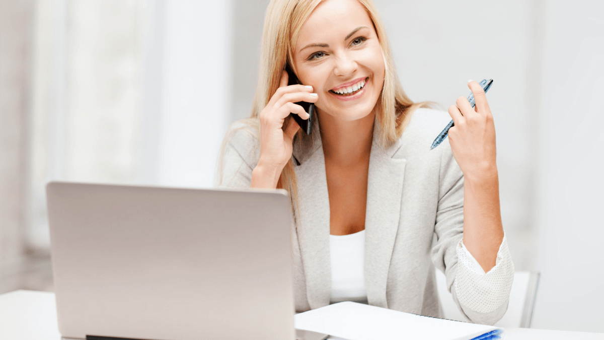 Business woman talking on the phone and using laptop