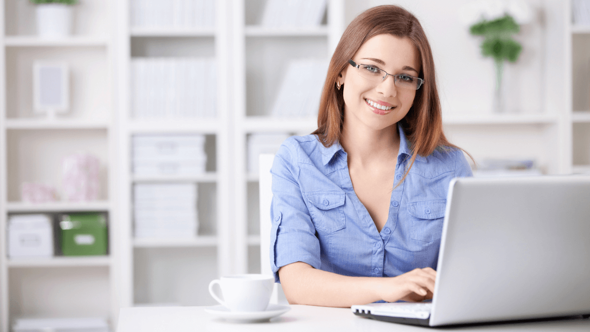young girl smiling using laptop