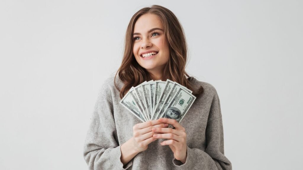 Woman Smiling Holding Money Bills