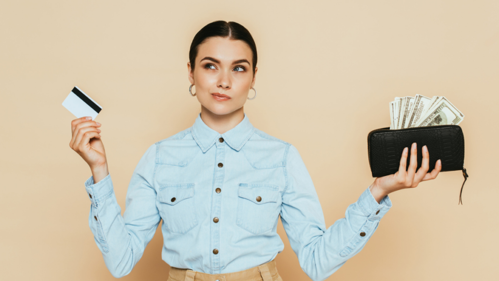 Woman contemplating while handling a wallet and cash