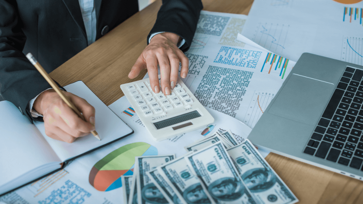 Finance professional calculating expenses at the office